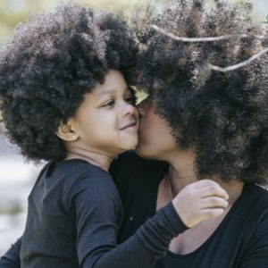 A Woman Kissing a Young Girl