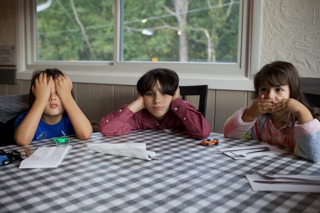 3 kids sitting at a table